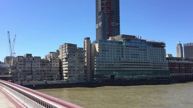 LONDON - MAY 2015: City buildings over Thames. London attracts 30 million people annually.