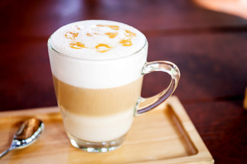 Hot coffee in a white cup on table