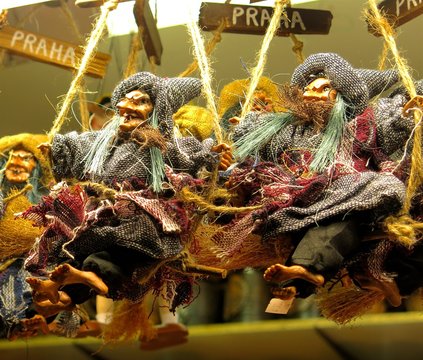 toy witch dolls on broomsticks at market in Prague, Czech republic