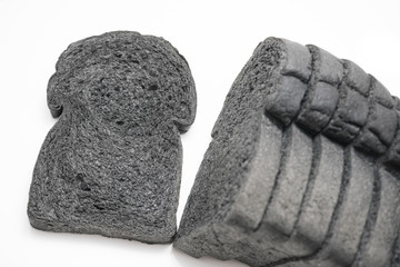 loaf slide of charcoal bread black bread isolated on white