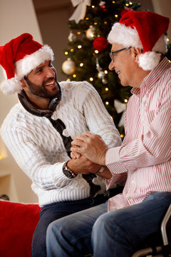 happy family - elderly father with his son spending Christmas holiday.