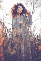 Fototapeta premium Fashion beautiful lady in autumn landscape