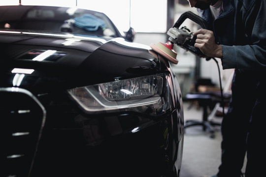 Car Detailing - Hands With Orbital Polisher In Auto Repair Shop. Selective Focus.