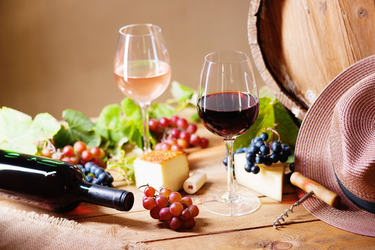 Wine glasses, cheese, grapes, hat and barrel 