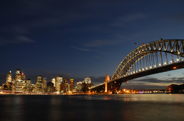 Harbour bridge and skyscraper of Sydney by night photographed from Kirribilli