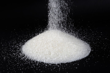 Granulated sugar on a black background