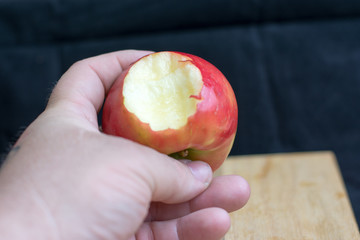 male hand holding apple