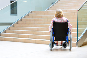 woman on wheelchair and stairs - 176540763