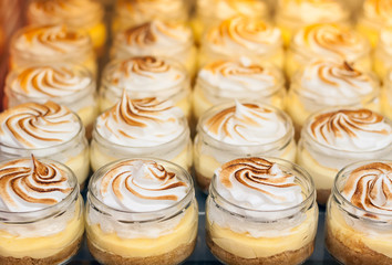 Showcase of a confectionery. Desserts made from meringue and cream.
