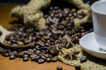 Coffee cup, coffee beans on wooden table