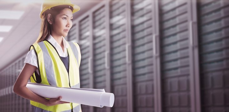Composite image of architect woman with yellow helmet and plans