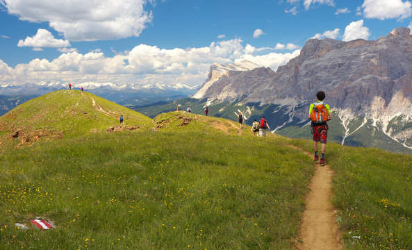 Group of walking tourists in the mountains, Dolomites, Italy