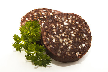 raw irish black pudding with oatmeal on bright with parsley