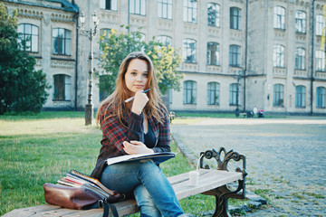 the student is sitting on the bench