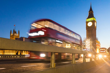 Big Ben and red bus in London at dusk