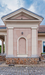 Detail of a country house, with a dead window and a tympanum