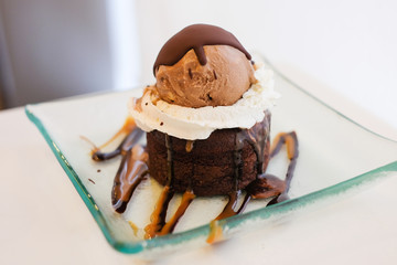 The chocolate lava cake topped with whipped cream, sauce and 