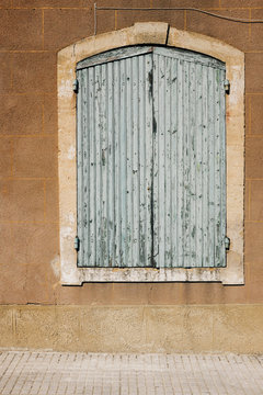 Painted window shutter on old house, Provence, France