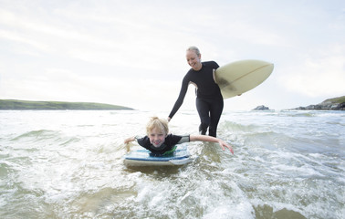 Mother and Son surfing together.