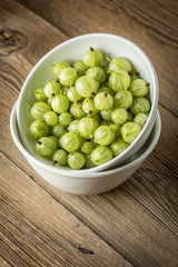 Fresh gooseberry in a white bowl.