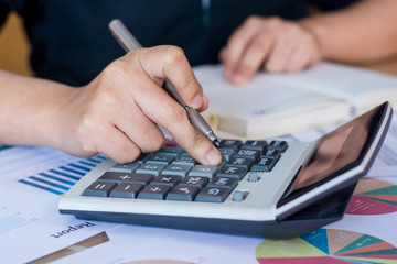woman hand using calculator and writing make note with calculate