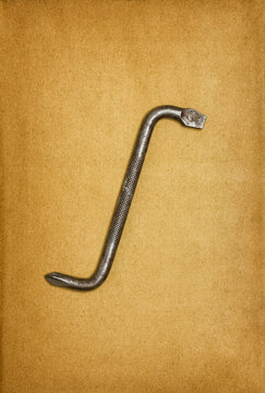 Old offset screwdriver on aged paper background