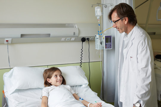 Doctor visiting a child patient in the hospital room