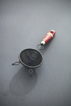 kitchen utensils on grey background backlit with shadows