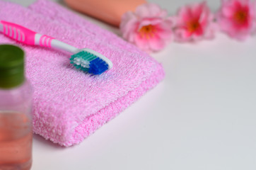 Obraz na płótnie Canvas Pink toothbrush on a pink towel