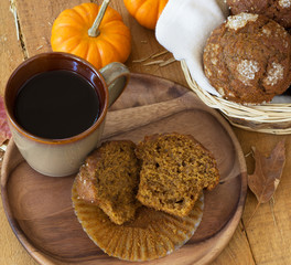 Pumpkin Muffin and Cup of Coffee on a Wooden Plate