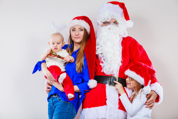 Mother, Santa and two daughters christmas family photo