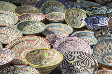 hand-painted dishes of a multitude of colors in a traditional art market