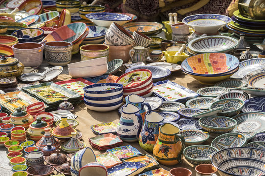 hand-painted dishes of a multitude of colors in a traditional art market