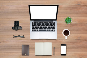 Top view, Flat lay style, Travel set, Working desk, computer, laptop, smart phone, coffee, mug, glasses, notebook and a lot of things on wooden colored background with clipping path.