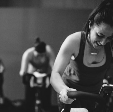 Young, happy woman enjoying working hard during spin cycle class