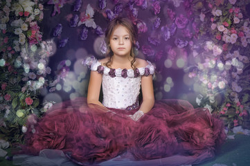 Girl in a purple dress on a floral background
