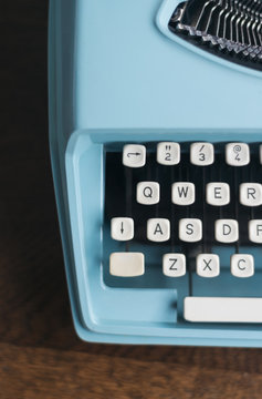 blue, retro typewriter with white keys, circa 1963