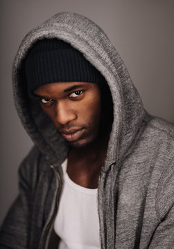African male model  in urban style on grey background.