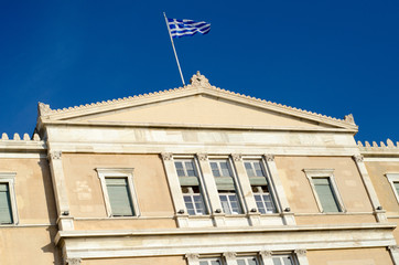 Greece flag on parliament building blue sky