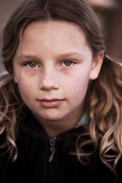 Portrait of Young Girl With Pigtails and Freckles