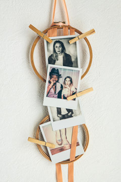  photos pegged onto embroidery hoops with ribbons