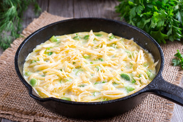 Omelette with onion and cheese in a frying pan