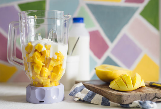 Mango cubes and yogurt in blender to make mango lassi