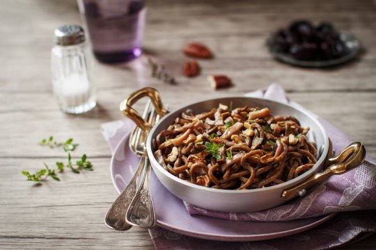 Homemade spaghetti with speck and mushrooms