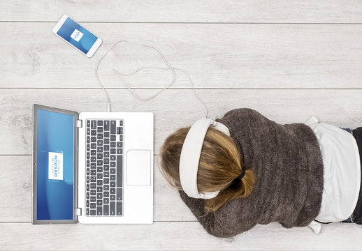 Laptop User with Headphones and Smartphone Mockup 1