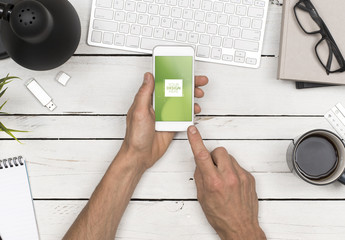 Top View Mockup of User's Hands Holding Smartphone at Desk 1 - Powered by Adobe