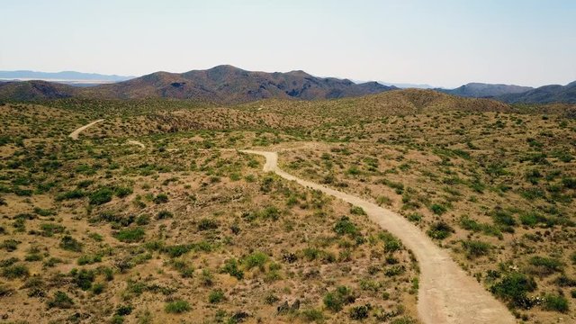 Aerial view dirt road at desert 4K