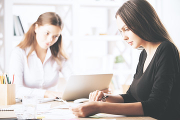 Pretty females doing paperwork