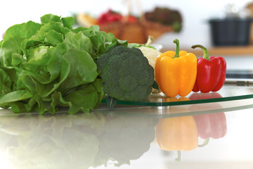 Kitchen interiors. Many vegetables and other meal at glass table are ready for been cooked soon