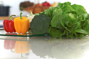 Kitchen interiors. Many vegetables and other meal at glass table are ready for been cooked soon